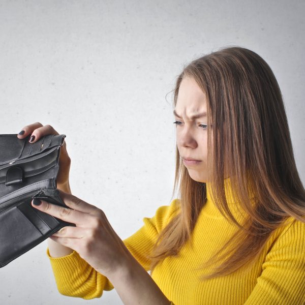 woman holding black wallet